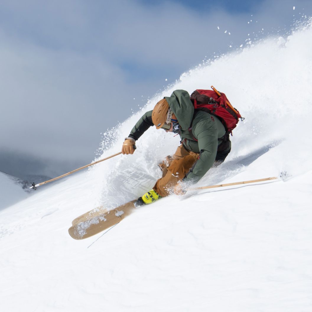 Snowboarder carving on a steep slope
