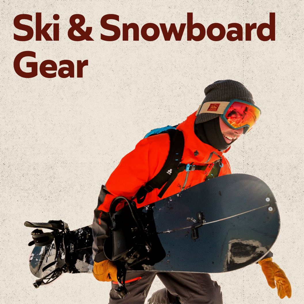 A snowboarder carrying a board 