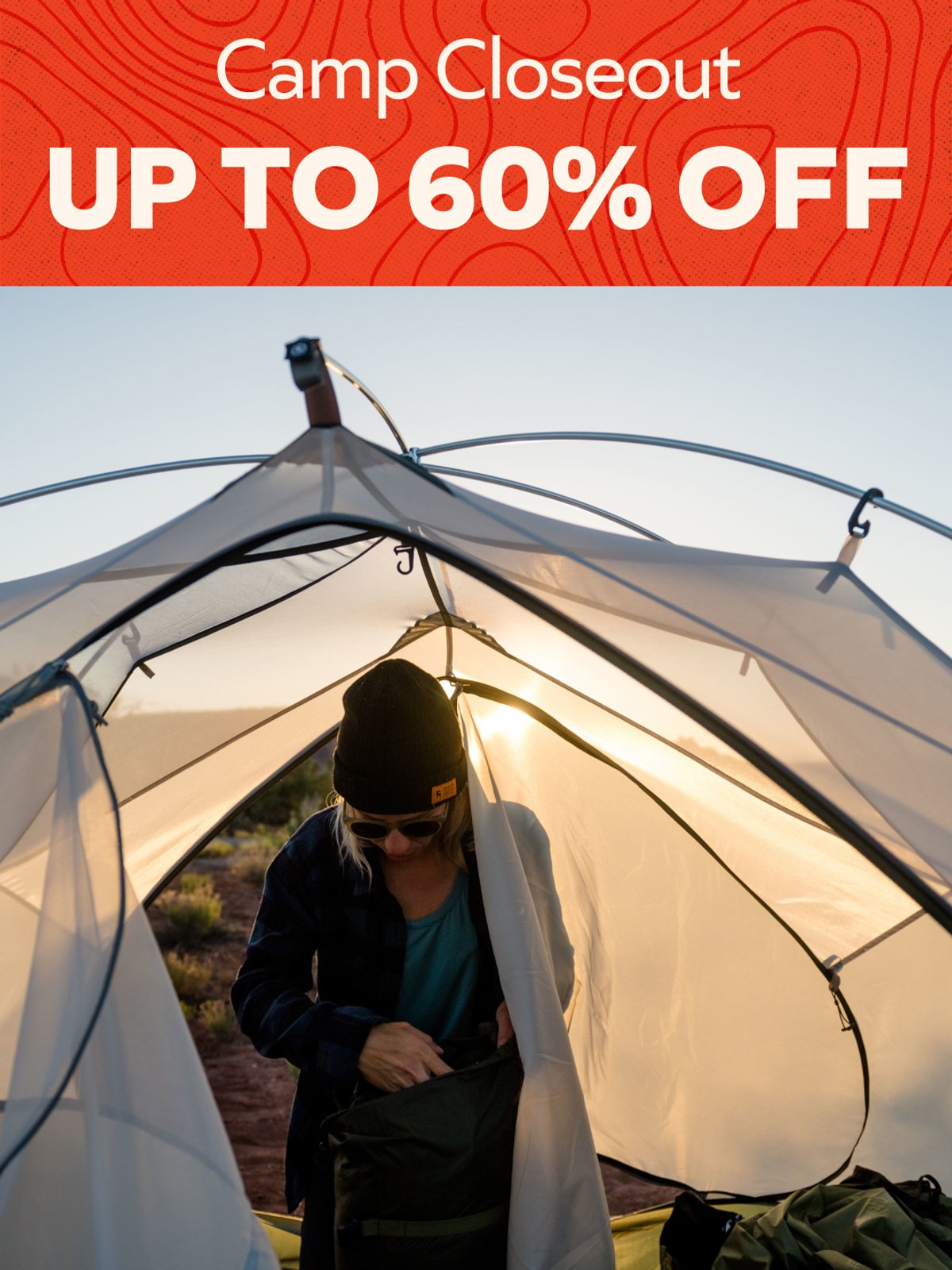 Camp Closeout up to 60% off — shop camping gear. Person inside tent at sunset.