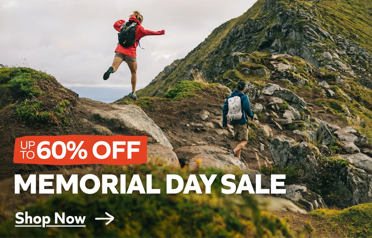 Two hikers scramble across a mountain ridge. The superimposed text reads: Up to 60% off memorial day sale. Shop now. 