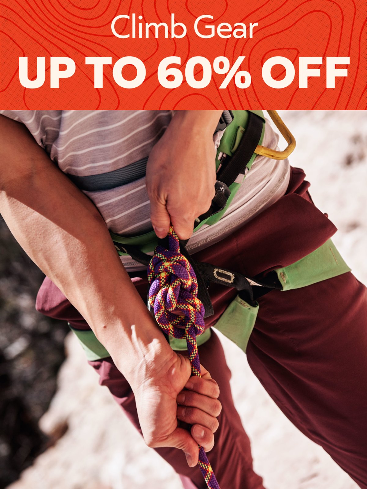 Up to 60% off climb gear — close-up of hands holding a vibrant climbing rope outdoors.